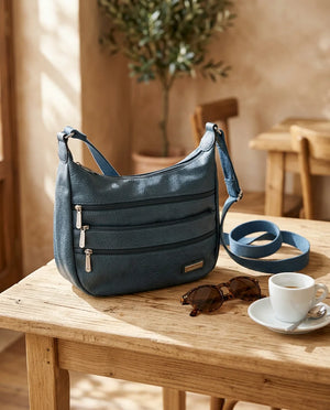 Borsa tracolla donna CHARRO con tre tasche frontali zip - Borsa su tavolo in una scena ambientata