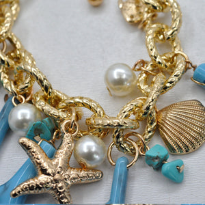 Parure Collana e bracciale turchese lunga stelle marine corallo perle rami mare